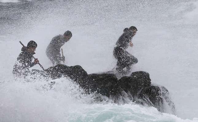 A trio of ‘percebeiro’ stake out a rock.