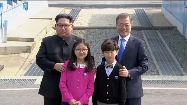 Moon Jae-in and Kim Jong-un pose for a photo with children at the truce village of Panmunjom.