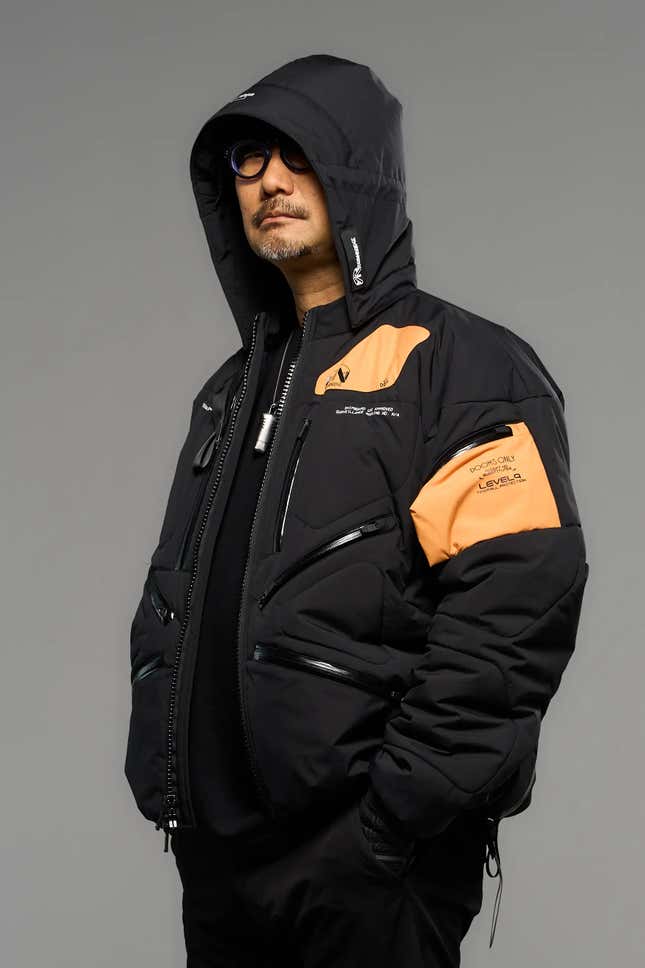 1) Sleek limited edition Death Stranding 2 jacket displayed on a bust2) Close-up of the high-quality stitches and fabric of the Death Stranding 2 jacket3) Detailed view of the unique Death Stranding 2 logo on the jacket 4) Lifestyle shot of a model posing in the stylish Death Stranding 2 jacket 5) New Death Stranding 2 jacket paired with matching game accessories.6) Hero shot of the Death Stranding 2 jacket, highlighting its exclusive design.