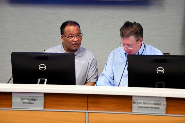 Bill Walker, Chairman of the Little Rock Municipal Airport Commission, left, and Bryan Malinowski, Executive Director of the Clinton National Airport, listen to a report by an airport director during a meeting of the commission on Tuesday, Feb. 27, 2024 in Little Rock, Ark. Bryan Malinowski, the executive director of Little Rock&#39;s airport who was injured earlier this week in a shootout with federal agents serving a search warrant at his home has died on Thuresday, March 21, 2024.(Stephen Swofford/Arkansas Democrat-Gazette via AP)