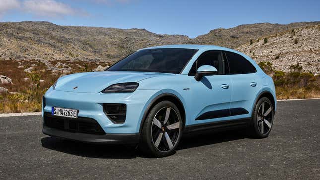 A light blue Porsche Macan stopped on a remote road