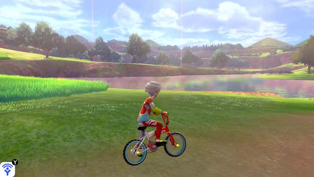 A screenshot of Pokémon Sword. The trainer is on his bike in the wild area.