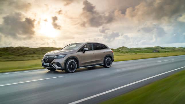 A photo of a beige Mercedes-Benz EQE SUV driving on a highway. 