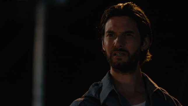 Tim stares confused, in the dark.