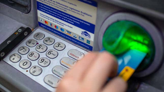 A client swipes their credit card at an ATM.