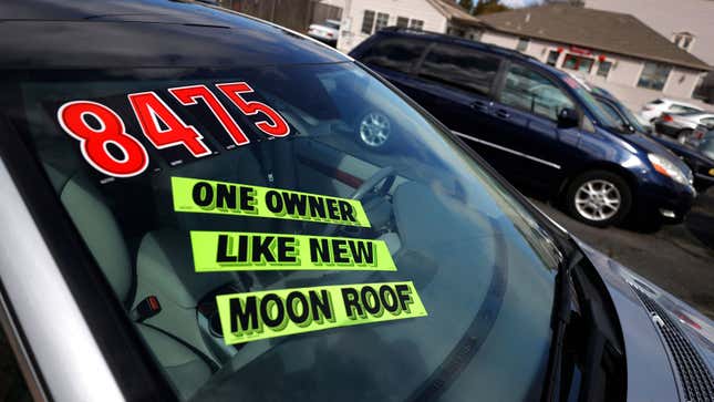 A photo of a car windshield with a price for sale written across it. 