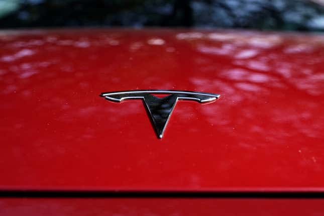 FILE - A Tesla logo is seen on a vehicle on display in Austin, Texas, Feb. 22, 2023. Shares of Tesla tumbled at the opening bell Thursday, Jan. 25, 2024 as the electric vehicle, solar panel and battery maker warned investors of slower sales growth in 2024 after putting up quarterly financial results that were weaker than most had expected. (AP Photo/Eric Gay, File)