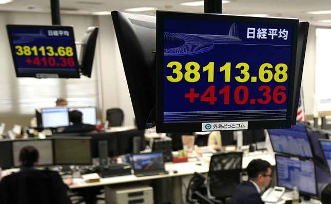 Monitors show Nikkei stock index, yellow, at a foreign exchange trader&#39;s company in Tokyo, Thursday, Feb. 15, 2024. Shares rose in Asia on Thursday after Wall Street stocks recovered much of their sharp losses from a day before.(Kyodo News via AP)