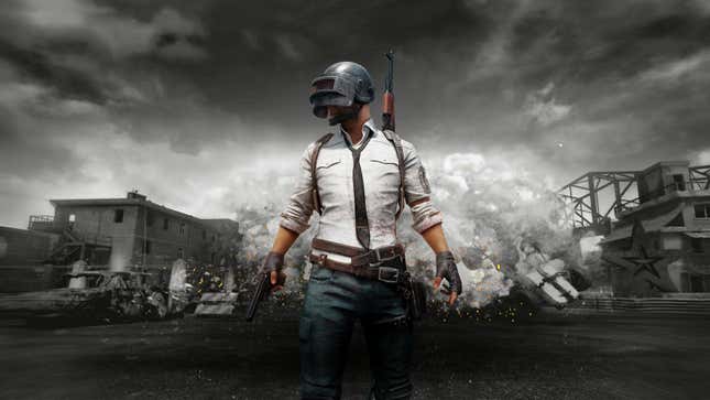 A armed dude stands in front of dilapidated structures in PlayerUnknown’s Battlegrounds.