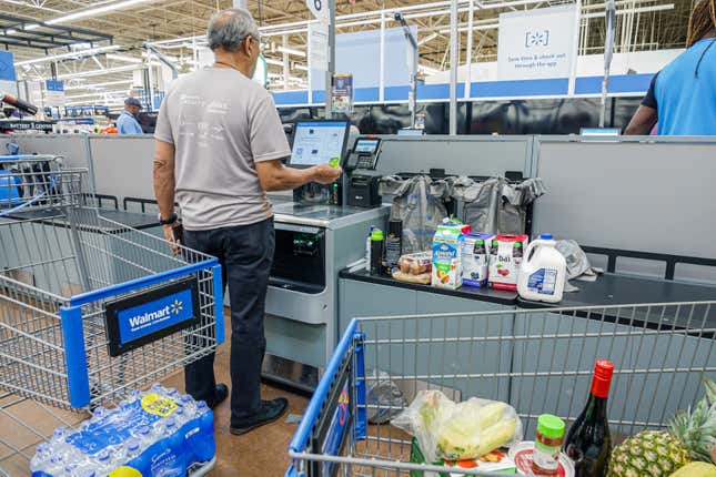 A Walmart customer using a self checkout kiosk in North Miami Beach, Florida. 