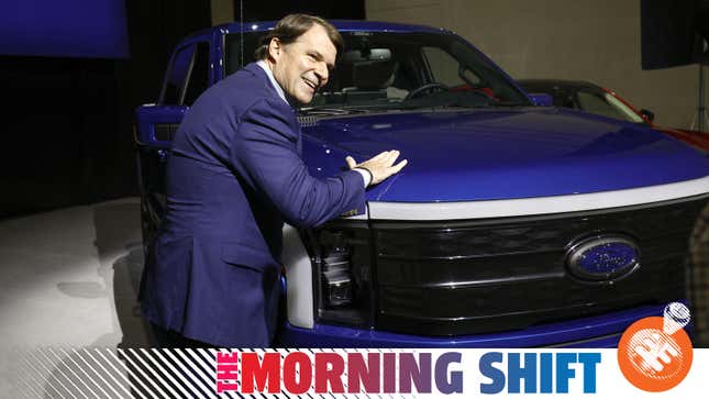 Ford CEO Jim Farley poses with an F-150 Lightning electric pickup truck.