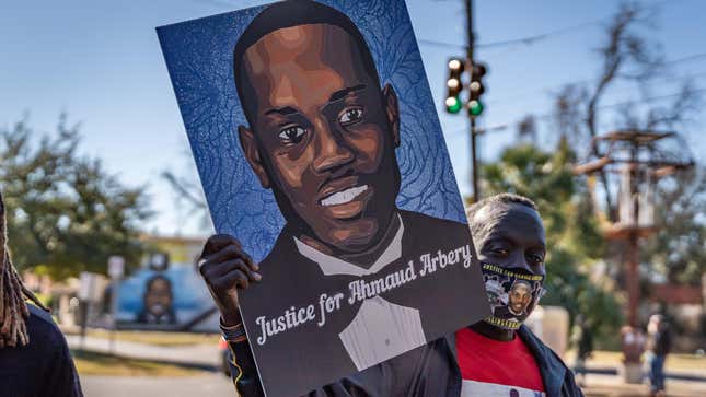 Brunswick, Georgia USA - January 18, 2021: Marcus Arbery, Sr., father of Ahmaud Arbery, carries a portrait of his son in the Rev. Martin Luther King, Jr. Day Parade.