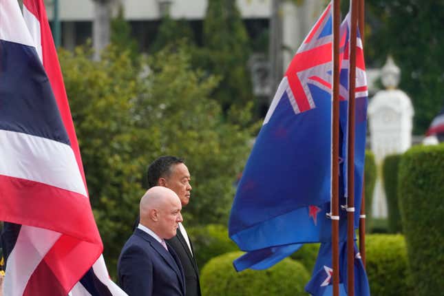 New Zealand&#39;s Prime Minister Christopher Luxon, foreground, escorted by Thailand&#39;s Prime Minister Srettha Thavisin, listens to national anthems during a welcoming ceremony at the Government House in Bangkok, Thailand, Wednesday, April 17, 2024. (AP Photo/Sakchai Lalit)