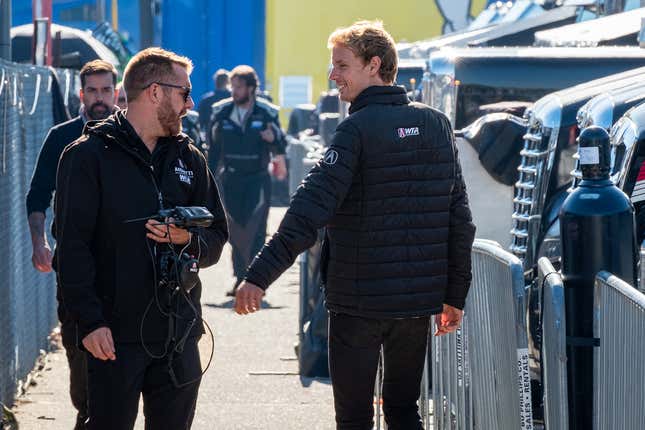 Brendan Hartley exchanges pleasantries on his way to work.