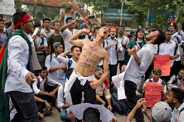 Bangladeshi students shout slogans and block a road during a protest in Dhaka, Bangladesh, Aug. 04.