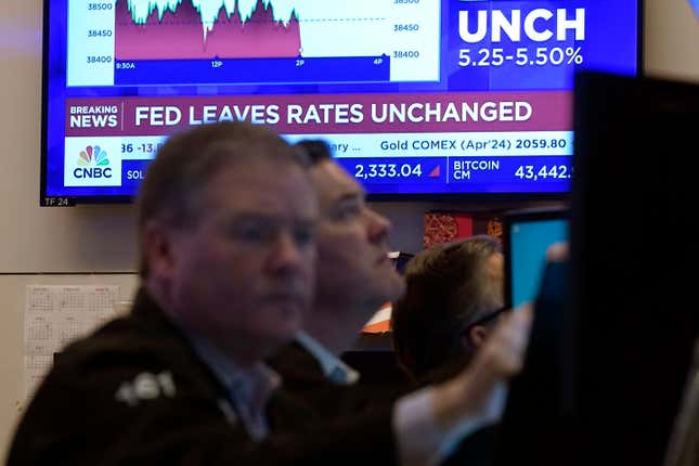 FILE - A television screen on the floor of the New York Stock Exchange displays the Federal Reserve&#39;s decision on interest rates, Jan. 31, 2024. From Wall Street investors to car dealers to potential home buyers, many Americans are eager for the Federal Reserve to start cutting its benchmark interest rate and reducing borrowing costs throughout the economy (AP Photo/Richard Drew, File)