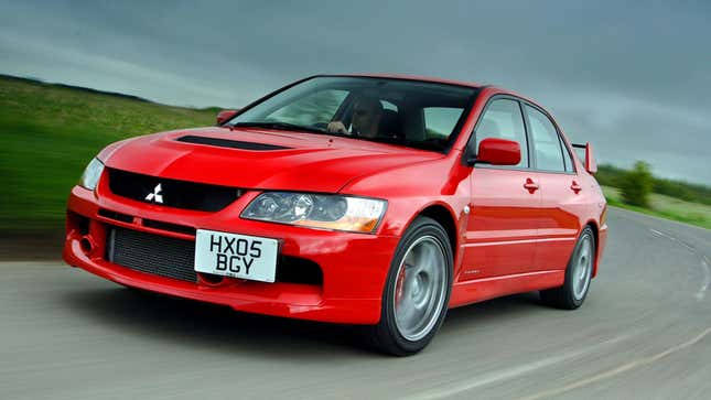 A photo of a red Mitsubishi Lancer Evo sedan. 