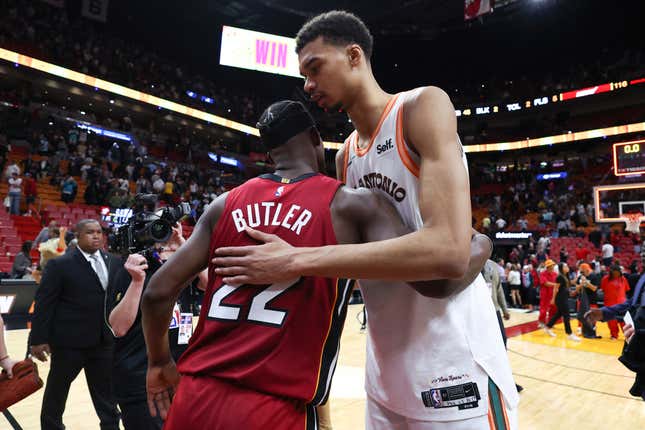MIAMI, FLORIDA - FEBRUARY 07: Jimmy Butler #22 of the Miami Heat and Victor Wembanyama #1 of the San Antonio Spurs embrace on the court after their game at Kaseya Center on February 07, 2024 in Miami, Florida. NOTE TO USER: User expressly acknowledges and agrees that, by downloading and or using this photograph, User is consenting to the terms and conditions of the Getty Images License Agreement. (Photo by Megan Briggs/Getty Images)
