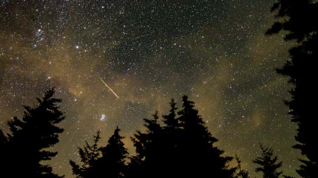 In this 30 second exposure, a meteor streaks across the sky during the annual Perseid meteor shower, Wednesday, Aug. 11, 2021, in Spruce Knob, West Virginia.