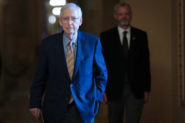 WASHINGTON, DC - DECEMBER 18: Senate Minority Leader Mitch McConnell (L) (R-KY) walks to the senate chamber inside the U.S. Capitol to deliver remarks on December 18, 2023 in Washington, DC. Bipartisan negotiations to reach an agreement on a new border policy continue. 