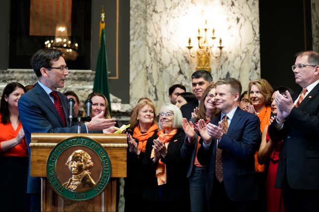 FILE -Washington Attorney General Bob Ferguson introduces Sen. Jamie Pedersen, D-Seattle, second from right, after making remarks Tuesday, April 25, 2023, at the Capitol in Olympia, Wash. A federal judge on Friday, March 8, 2024 rejected a challenge to a Washington state law that cleared the way for lawsuits against the gun industry in certain cases. The measure was one of three bills signed by Democratic Gov. Jay Inslee last year seeking to address gun violence. (AP Photo/Lindsey Wasson, File)