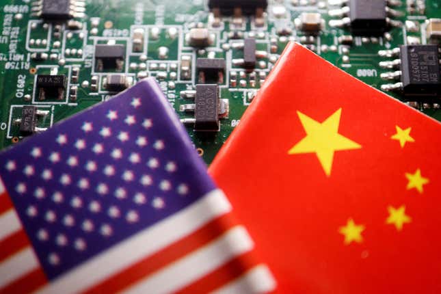 part of a US flag and Chinese flag in the frame with a semiconductor in the background