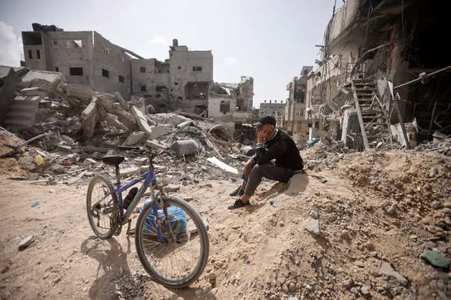 A Palestinian sits among destruction after Israeli forces left Khan Younis, Gaza Strip, Wednesday, March 6, 2024. (AP Photo/Mohammed Dahman)