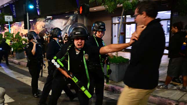 Police shove an unarmed  abortion rights demonstrators after the overturning of Roe vs.  Wade in downtown Los Angeles, on June 24, 2022.