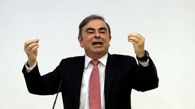 A photo of ex-Nissan boss Carlos Ghosn waving his arms. 