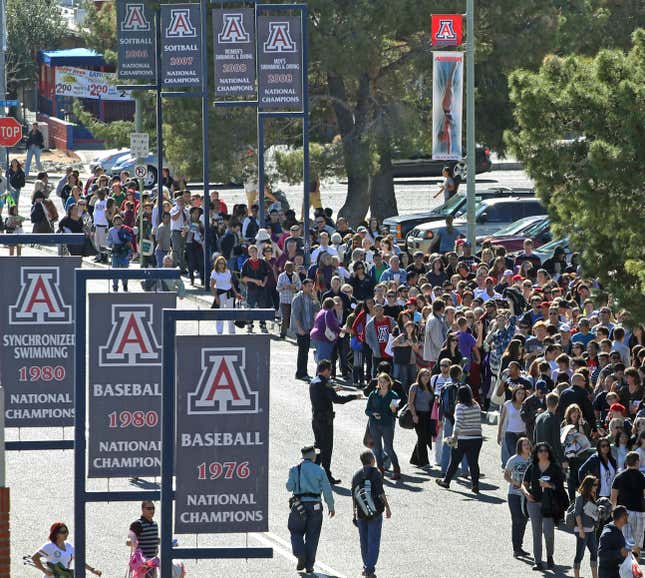 FILE - People line up to get into a memorial service at McKale Memorial Center on the University of Arizona campus, Jan. 12, 2011, in Tucson, Ariz. On Wednesday, Dec. 13, 2023, the University of Arizona unveiled an extensive financial recovery plan to address its $240 million budget shortfall. (AP Photo/Chris Carlson, File)