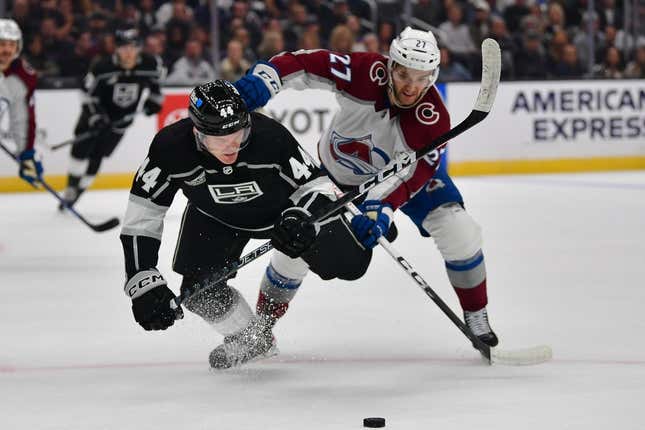 Oct 11, 2023; Los Angeles, California, USA; Colorado Avalanche left wing Jonathan Drouin (27) plays for the puck against Los Angeles Kings defenseman Mikey Anderson (44) during the first period at Crypto.com Arena.