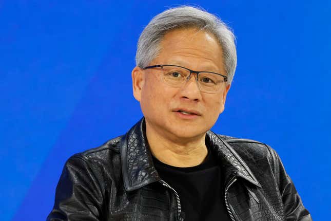 close up of Jensen Huang speaking in front of a royal blue backdrop