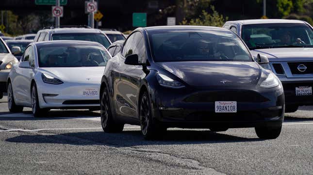 Tesla vehicles drive on the street on February 2, 2024 in San Bruno, California