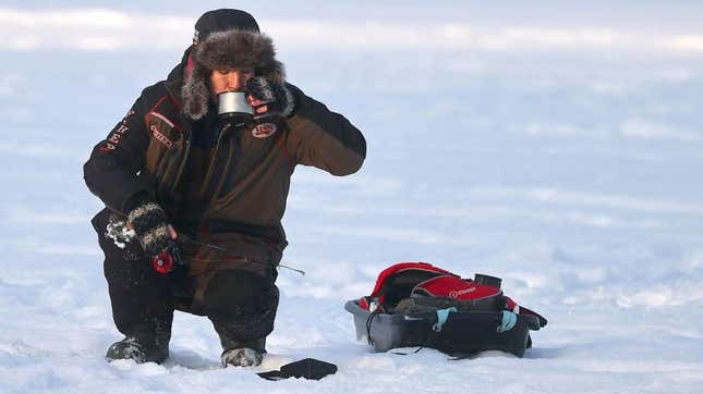 Ice fisherman drinking coffee on ice