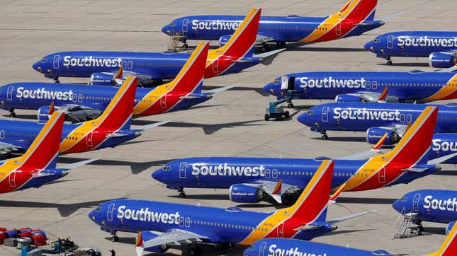 A number of grounded Southwest Airlines Boeing 737 MAX 8 aircraft on a tarmac on a sunny day