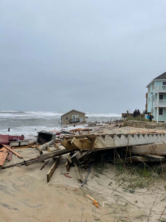 View of mostly submerged house in ocean