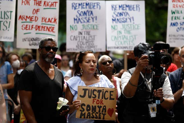 Demonstrators with signs protest the killing of Sonya Massey by a Springfield, Illinois sheriff’s deputy, in Washington Square Park on July 28, 2024 in New York City