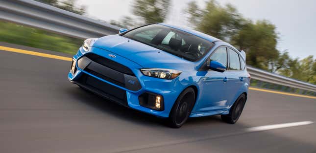 Very angry blue hatchback driving presumably very fast on a banked track.