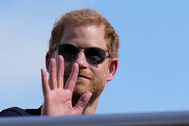 FILE - Britain&#39;s Prince Harry, The Duke of Sussex, waves during the Formula One U.S. Grand Prix auto race at Circuit of the Americas, on Oct. 22, 2023, in Austin, Texas. Prince Harry dropped his libel lawsuit Friday Jan. 19, 2024 against the publisher of the Daily Mail tabloid following a ruling in which a judge cast doubt on his case. (AP Photo/Nick Didlick, File)