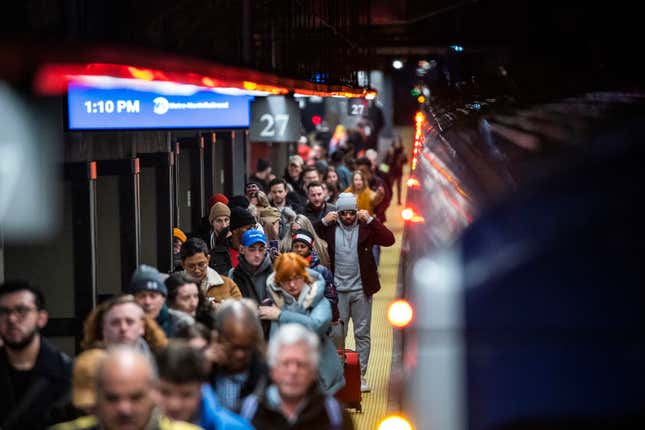 Travelers walk the ramp as they arrive to Grand Central Station in New York, Thursday, Dec. 21, 2023. (AP Photo/Eduardo Munoz Alvarez)