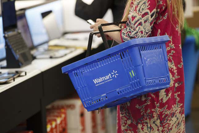 A customer carries a shopping basket at a Walmart in Burbank, California on Nov. 22, 2016. 