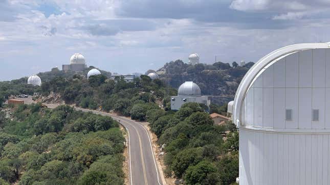In this image taken June 18, Kitt Peak’s telescopes appear to have been spared the worst of the wildfire.