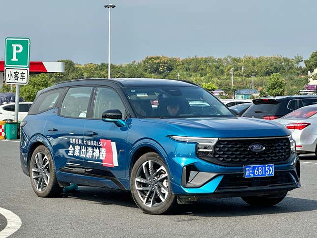 A blue Ford Edge L with a graphic on the side
