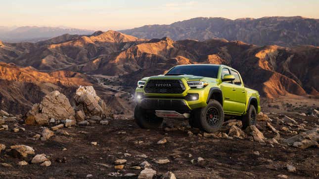 A green Toyota Tacoma truck. 