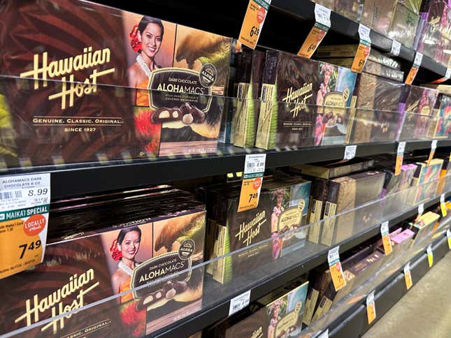 Packages of macadamia nuts are displayed on store shelves on Friday, April 26, 2024, in Honolulu. For decades, tourists to Hawaii have brought home gift boxes of the islands&#39; famous chocolate-covered macadamia nuts for friends and family. (AP Photo/Audrey McAvoy)