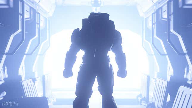 Master Chief stands in front of a blue light portal in Halo Infinite.