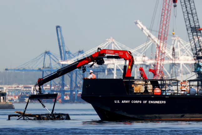 The U.S. Army Corps of Engineers debris removal vessel The Reynolds works near the collapsed Francis Scott Key Bridge, Monday, April 15, 2024, in Baltimore. The FBI confirmed that agents were aboard the Dali conducting court-authorized law enforcement activity. (AP Photo/Julia Nikhinson)