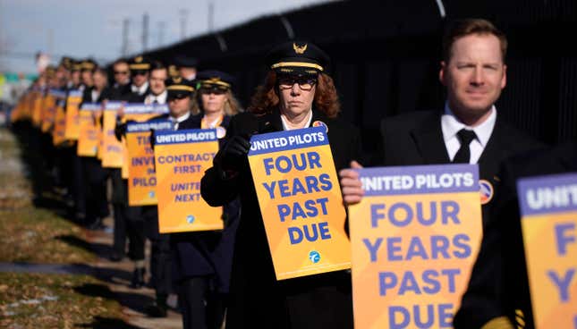 FILE - United Airlines pilots as well as other supporters walk an informational picket line to signify the pilot union&#39;s commitment to attain an industry-leading contract on Tuesday, Nov. 15, 2022, outside the United Airlines flight training center in east Denver. Pilots at United Airlines have ratified a new four-year contract. Their union said Friday, Sept. 29, 2023, the deal will raise pay and improve benefits, and is worth more than $10 billion. (AP Photo/David Zalubowski, File)