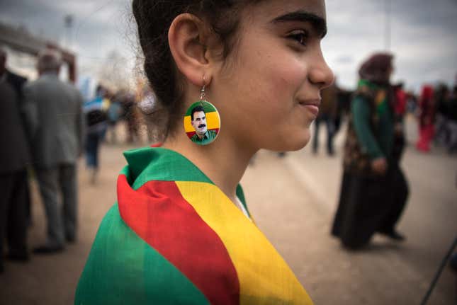 A girl poses with Abdullah Ocalan earrings. Ocalan founded the Kurdistan Workers’ Party (PKK), a militant group formed in the late 1970s to begin an armed struggle for a Kurdish autonomous state.