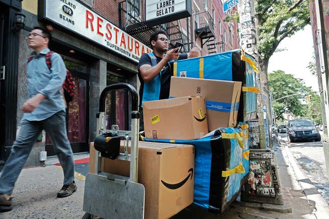An Amazon worker moves boxes in the East Village of New York City. 